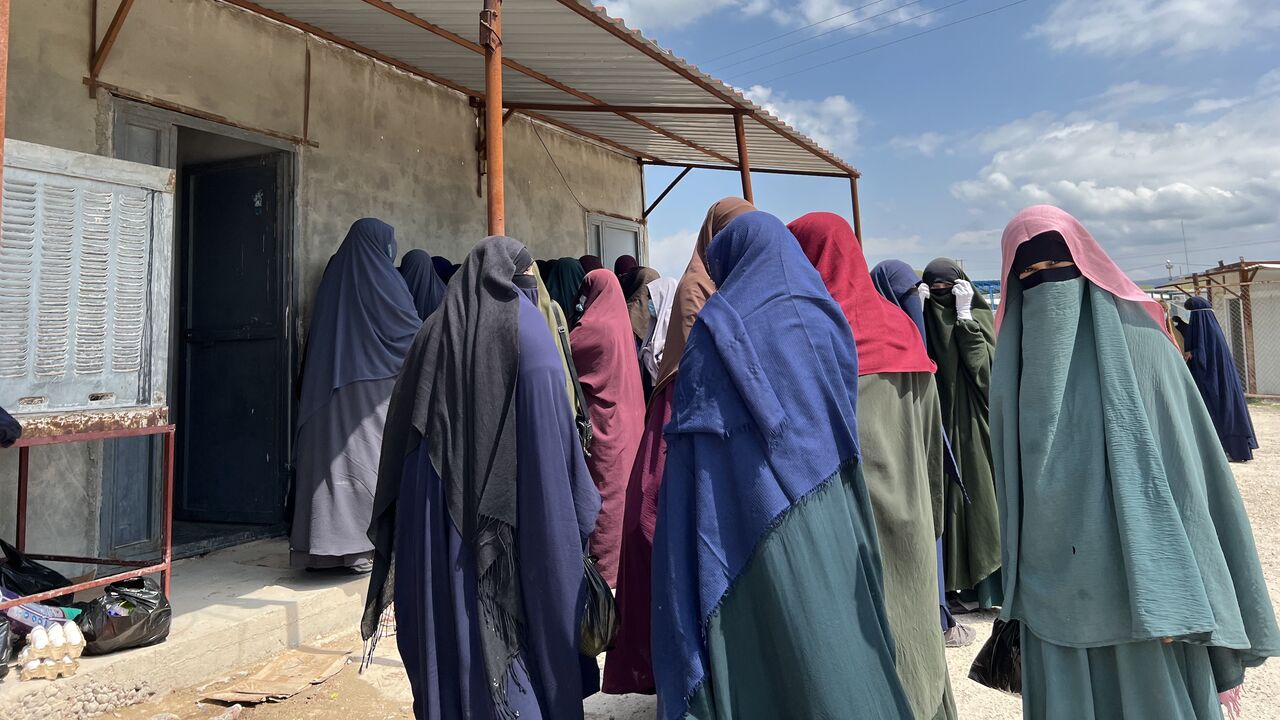 Islamic state women outside a Hawala money transfer shop at Roj camp in northeastern Syria, April 9, 2024.