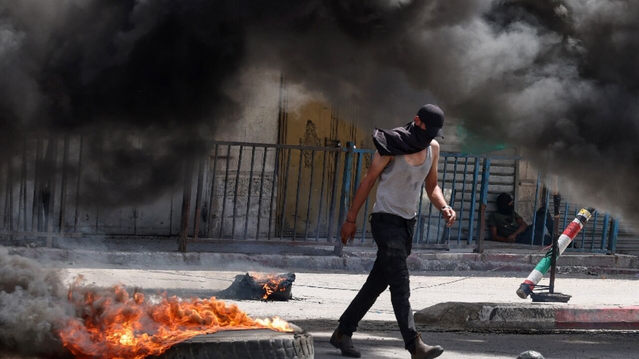 Protesters set fire to tyres in downtown Jenin Protesters set fire to tyres in downtown Jenin