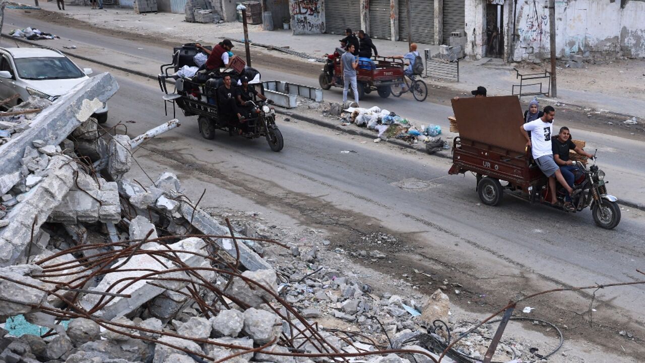 Palestinians transport their belongings as they flee Rafah in the southern Gaza Strip amid the ongoing conflict between Israel and the Hamas militant group