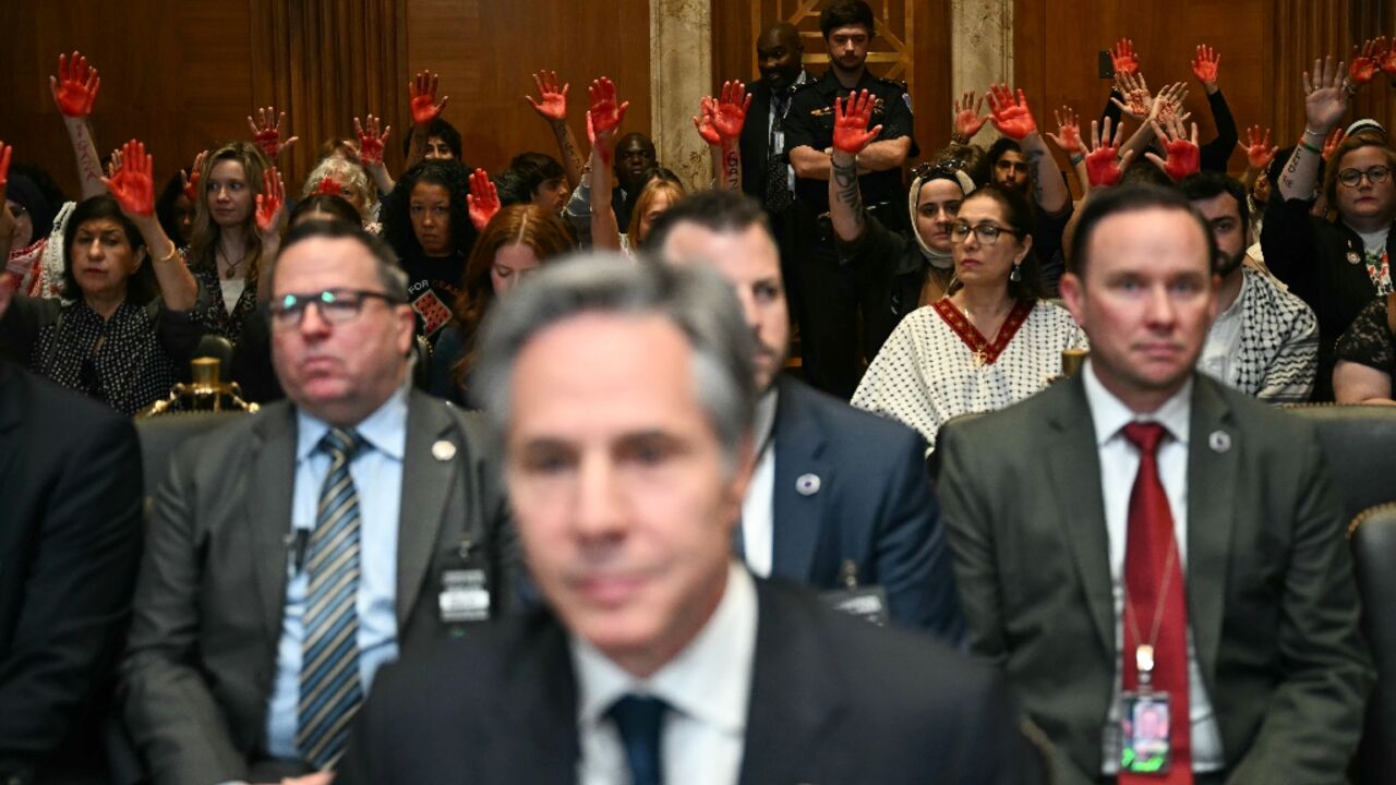 Pro-Palestinian demonstrators hold up painted hands in protest as US Secretary of State Antony Blinken testifies before a Senate Appropriations subcommittee Pro-Palestinian demonstrators hold up painted hands in protest as US Secretary of State Antony Blinken testifies before a Senate Appropriations subcommittee