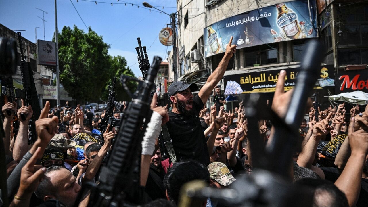 Armed Palestinian militants attend a group funeral of people killed in a raid by Israeli forces in Jenin, in the occupied West Bank