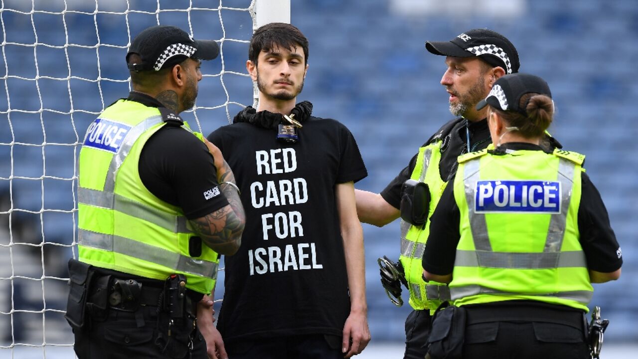 Delay: A demonstrator wearing a T-shirt with the slogan 'Red card for Israel' chained himself to a goalpost prior to the UEFA Women's Euro 2025 qualifier between Scotland and Israel in Glasgow