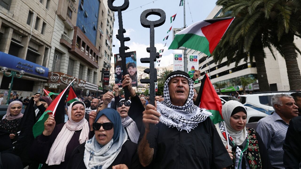 Palestinian protesters hold symbolic keys during a rally in the northern West Bank city of Nablus Palestinian protesters hold symbolic keys during a rally in the northern West Bank city of Nablus