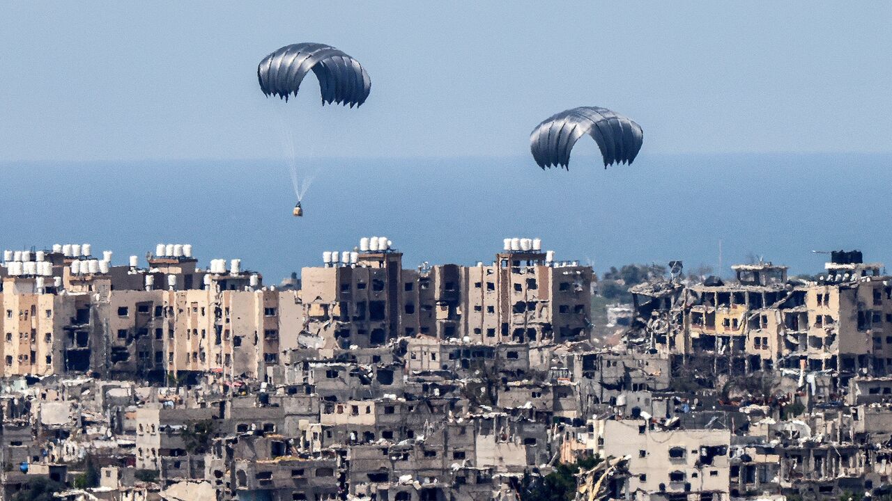This picture taken from Israel's southern border with the Gaza Strip shows parachutes of humanitarian aid dropping over the besieged Palestinian territory on March 26, 2024, amid the ongoing conflict between Israel and the militant group Hamas.