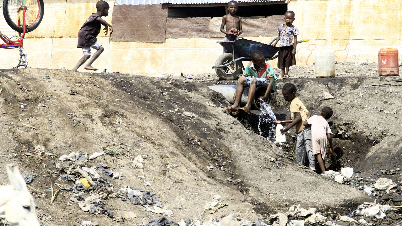 Children fill a bucket with water from a pipe in the southern Sudanese city of Gedaref on April 21, 2024. (Photo by AFP) (Photo by -/AFP via Getty Images)