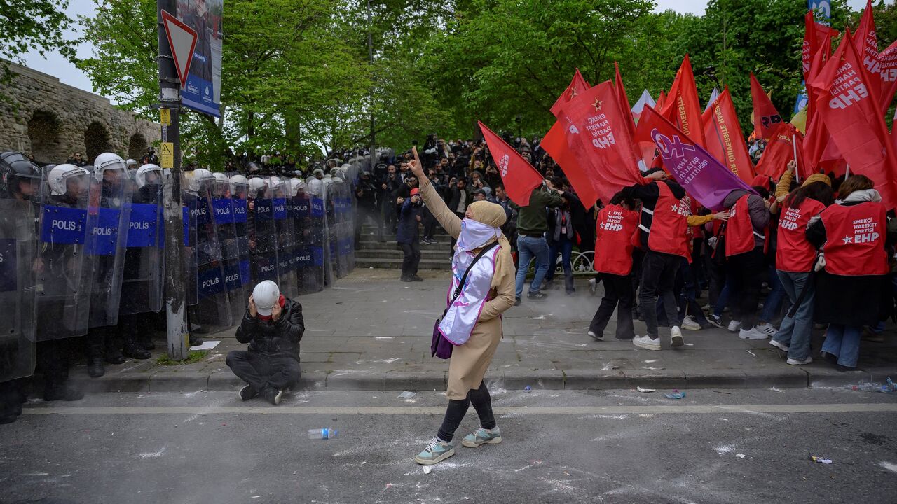 Protesters scuffle with riot police as they attempt to defy a ban and march on Taksim Square during a May Day (Labour Day) rally, marking International Workers' Day, at the Sarachane Park aqueduct in Istanbul, on May 1, 2024.