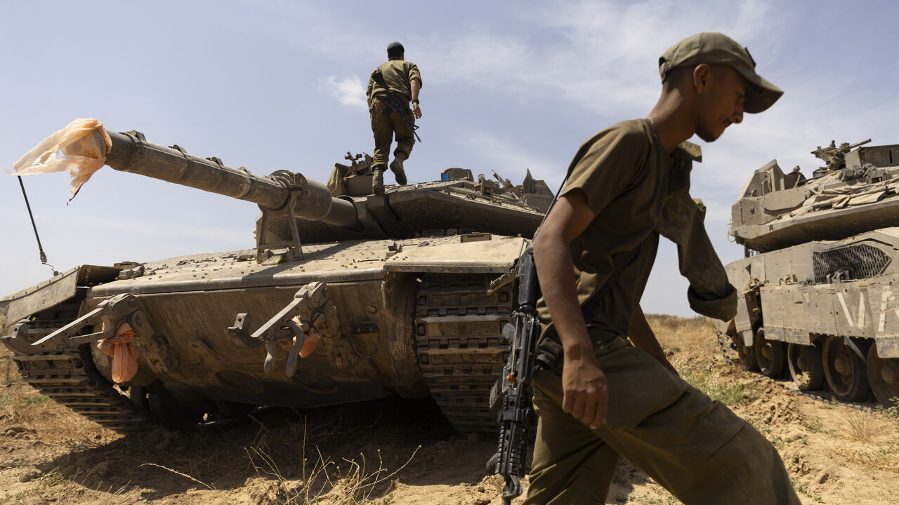 Israeli soldiers prepare a tank near the border with the southern Gaza Strip on May 2, 2024 in Southern Israel, Israel.