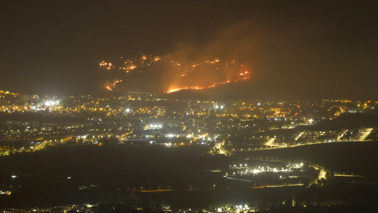 TOPSHOT - A picture shows a fire as a result of rockets launched from Lebanon, next to the northern Israel city of Kiryat Shmona, near the near the Lebanon border on May 10, 2024, amid ongoing cross-border clashes between Israeli troops and Hezbollah fighters. (Photo by Jalaa MAREY / AFP) (Photo by JALAA MAREY/AFP via Getty Images)