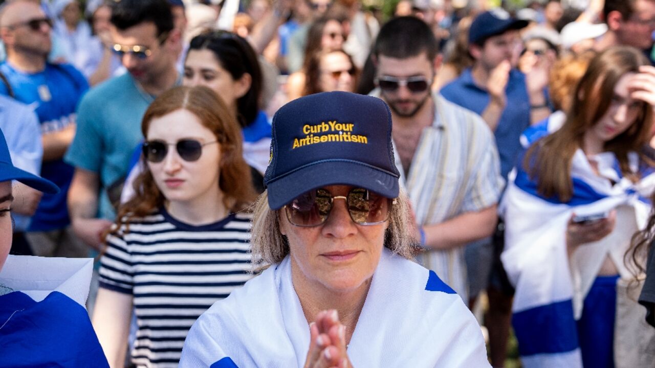 A woman wears a hat that reads "Curb Your Antisemitism" during a rally against campus antisemitism at George Washington University on May 2