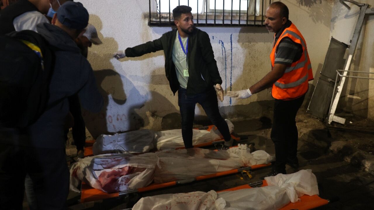 Medics prepare the bodies of Gazans killed in an Israeli strike on a camp for displaced Palestinians in Rafah on May 26, 2024