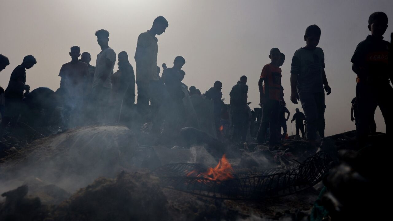 Palestinians gather at the site of an Israeli strike on a camp for internally displaced people in Rafah on May 27, 2024