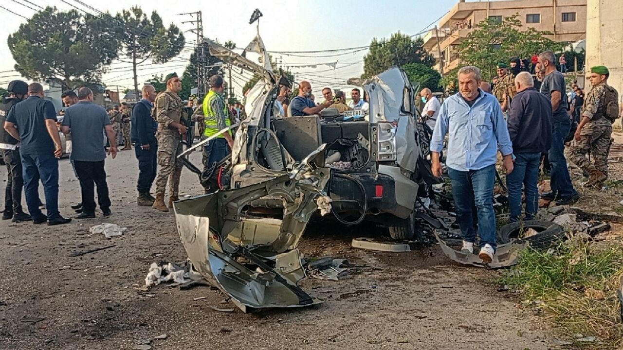 Lebanese soldiers and onlookers gather around the remnants of a car after it was hit by an Israeli strike, reportedly killing a Hamas commander, in Lebanon's Bekaa Valley Lebanese soldiers and onlookers gather around the remnants of a car after it was hit by an Israeli strike, reportedly killing a Hamas commander, in Lebanon's Bekaa Valley