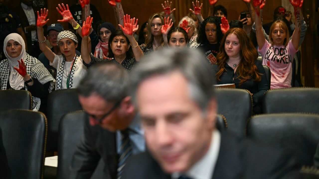 Pro-Palestinian demonstrators hold up painted hands in protest as US Secretary of State Antony Blinken testifies before a Senate Appropriations subcommittee 