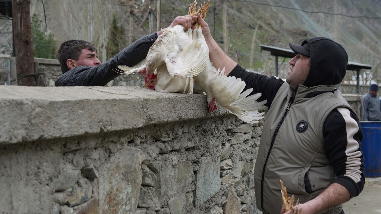 Tajiks and Afghans buy and sell at a bazaar in the Tajik town of Kalai-Khumb on the border with Afghanistan 