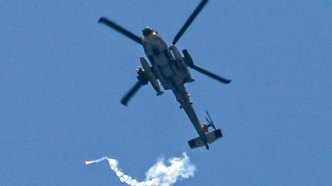 An Israeli attack helicopter fires flares over northwest Rafah on June 24, 2024 An Israeli attack helicopter fires flares over northwest Rafah on June 24, 2024