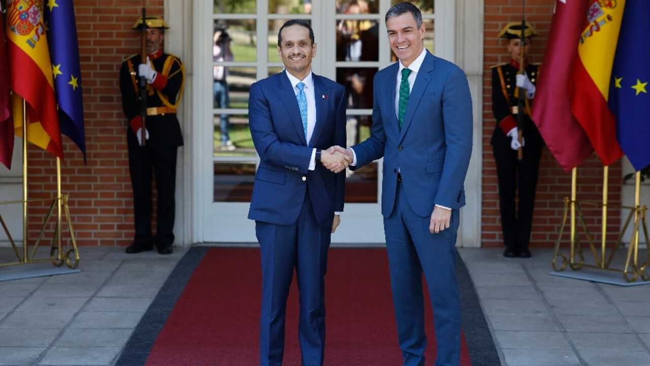 Qatar's Prime Minister Mohammed bin Abdulrahman al-Thani, left, says in Madrid that his country is still trying to 'bridge the gap' between Hamas and Israel