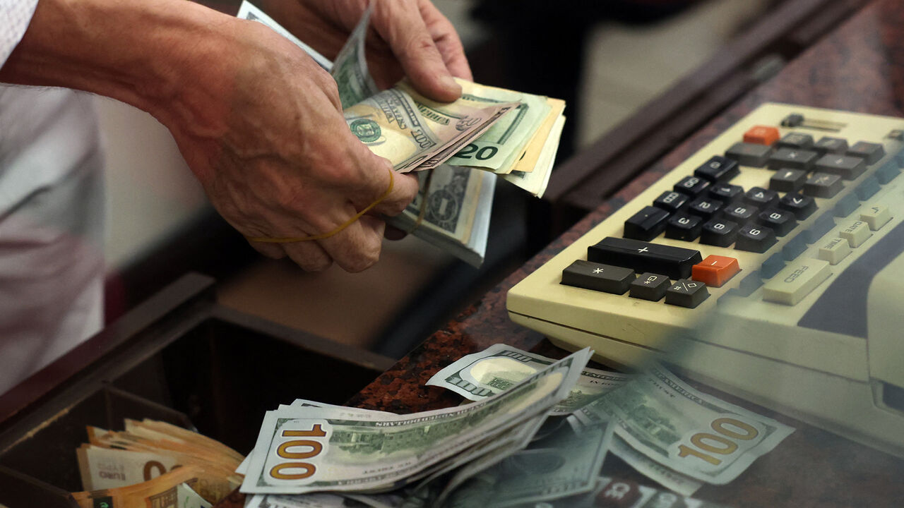 A teller counts US dollar bills at an exchange office in Ankara, Turkey, July 20, 2023.