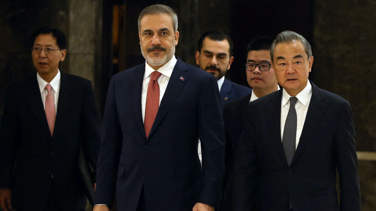 Turkish Foreign Minister, Hakan Fidan (C) welcomes his Chinese counterpart and Director of the Office of the Central Foreign Affairs Commission, Wang Yi (R) in Ankara, on July 26, 2023.