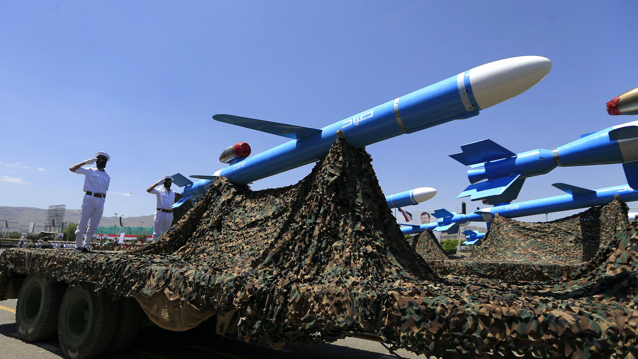 Houthi soldiers stand guard on a missile carrier during an official military parade marking the ninth anniversary of the Houthi takeover of the capital, Sanaa, on Sept. 21, 2023. 