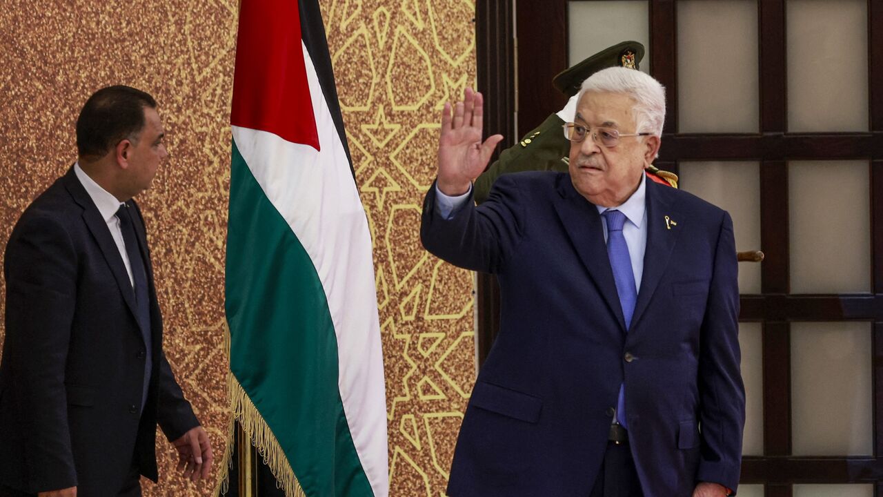 Palestinian Authority President Mahmud Abbas waves during a swearing-in ceremony of newly appointed ministers, on March 31, 2024, in Ramallah, in the occupied West Bank. 