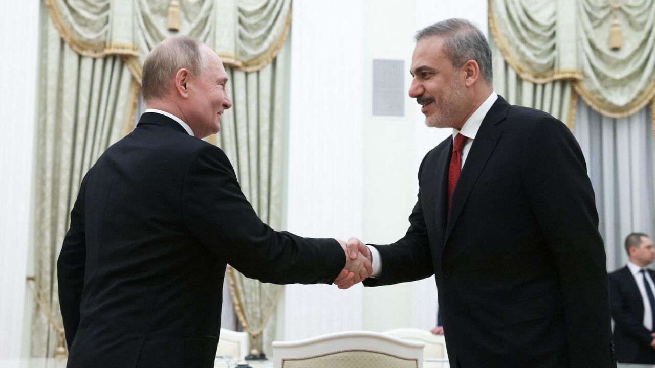 In this pool photograph distributed by Russian state agency Sputnik, Russia's President Vladimir Putin (L) attends a meeting with Turkish Foreign Minister Hakan Fidan (R) in Moscow on June 11, 2024. 