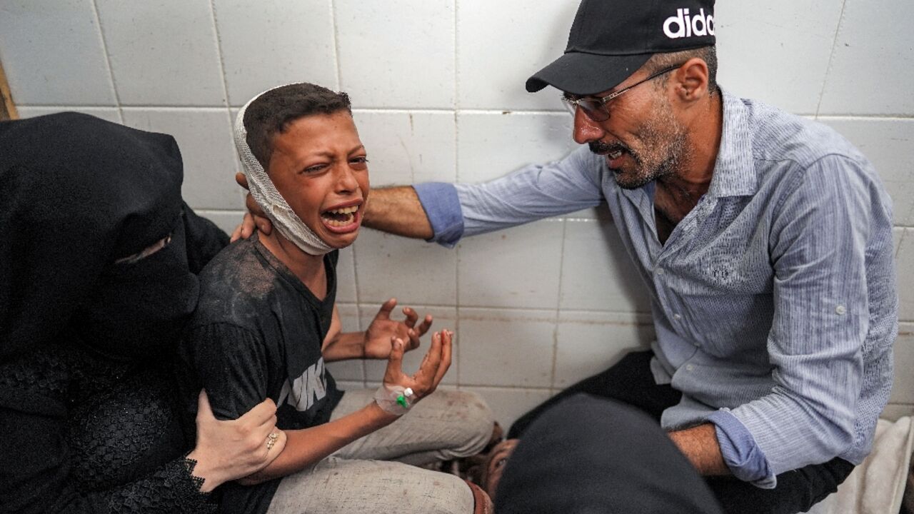 An injured boy mourning the loss of his father in a strike on central Gaza's Maghazi refugee camp, at a hospital morgue An injured boy mourning the loss of his father in a strike on central Gaza's Maghazi refugee camp, at a hospital morgue