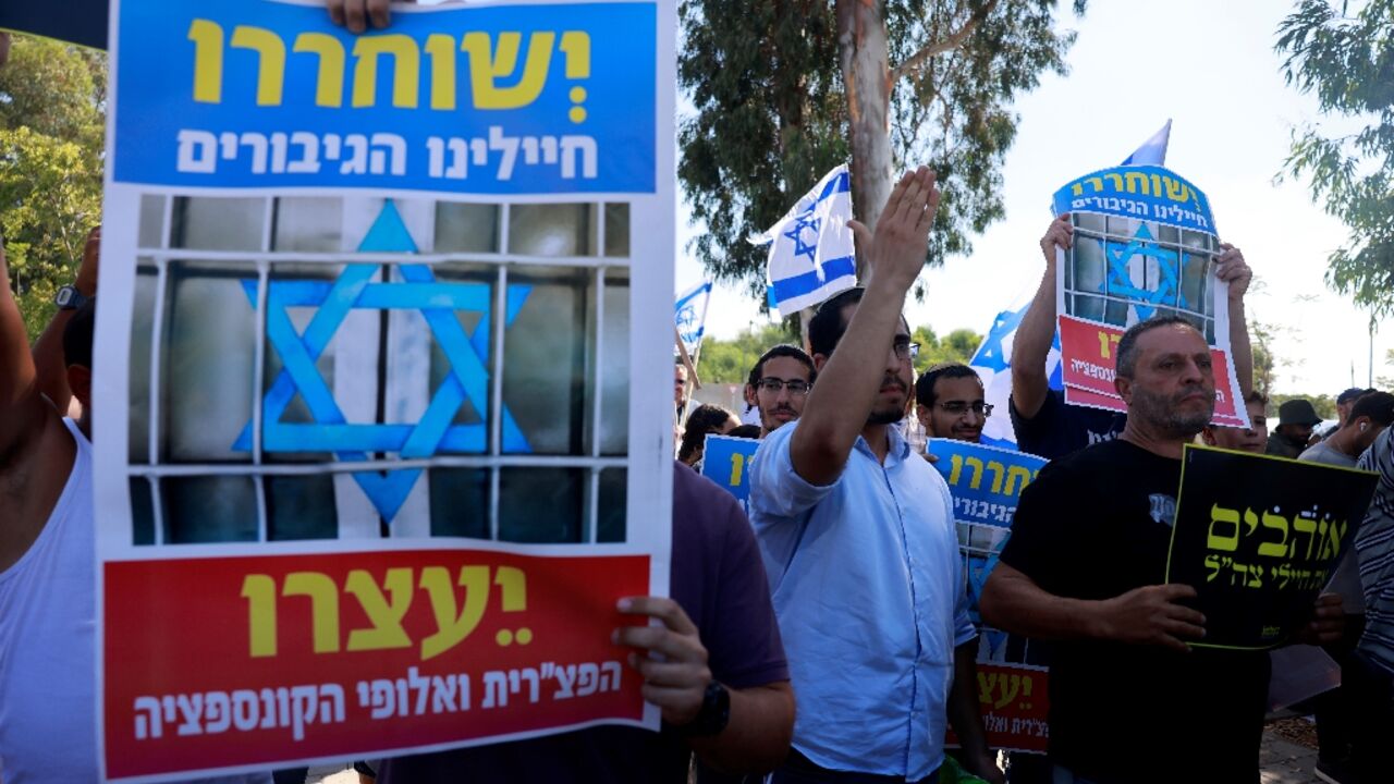 Right wing Israelis protest outside a military tribunal where soldiers arrested on suspicion of abusing a Palestinian prisoner were questioned on Tuesday to demand their release Right wing Israelis protest outside a military tribunal where soldiers arrested on suspicion of abusing a Palestinian prisoner were questioned on Tuesday to demand their release