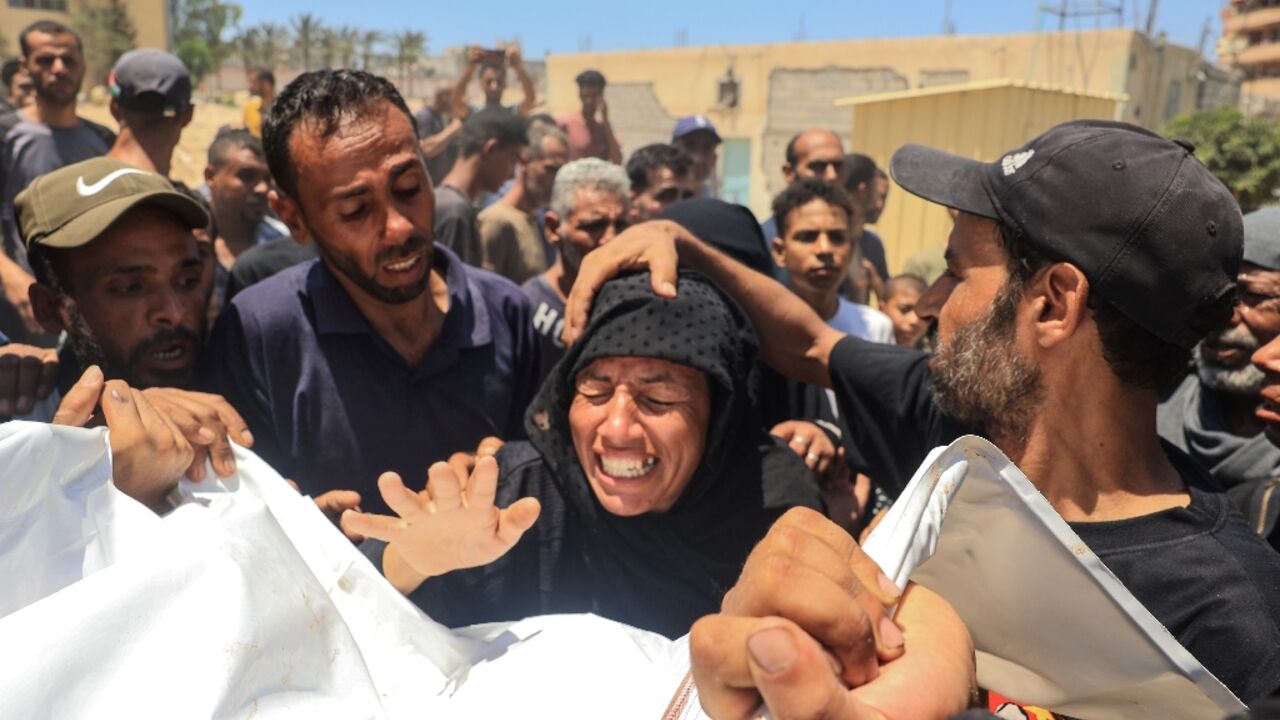 A woman reacts over the corpse of a family member after what the health ministry in Hamas-run Gaza called an Israeli strike on the Al-Mawasi area for displaced Palestinians