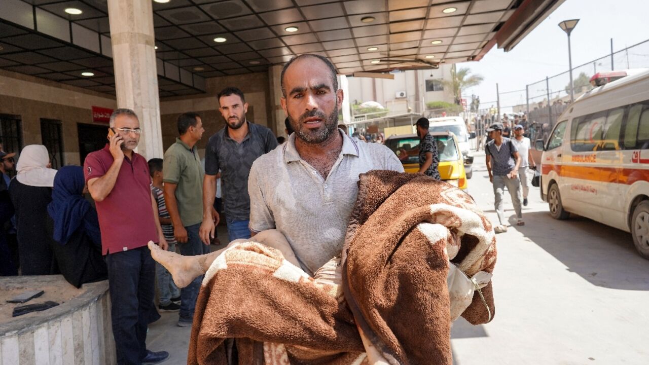 A man carries a child wrapped in a blanket at the Nasser hospital after Israeli strikes in the Khan Yunis area A man carries a child wrapped in a blanket at the Nasser hospital after Israeli strikes in the Khan Yunis area