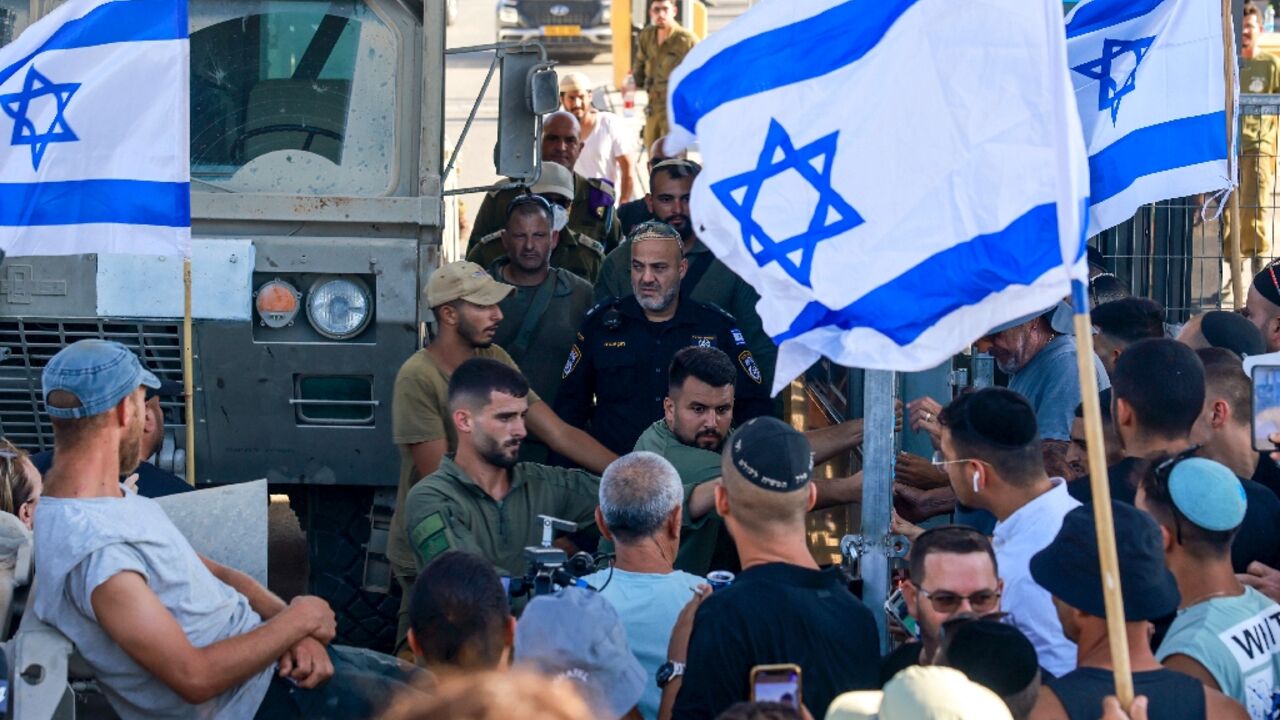 Israelis demonstrate next to the Sde Teiman military base near Beersheba, after nine soldiers were held for questioning, the army said, in a case of suspected abuse of a detainee Israelis demonstrate next to the Sde Teiman military base near Beersheba, after nine soldiers were held for questioning, the army said, in a case of suspected abuse of a detainee