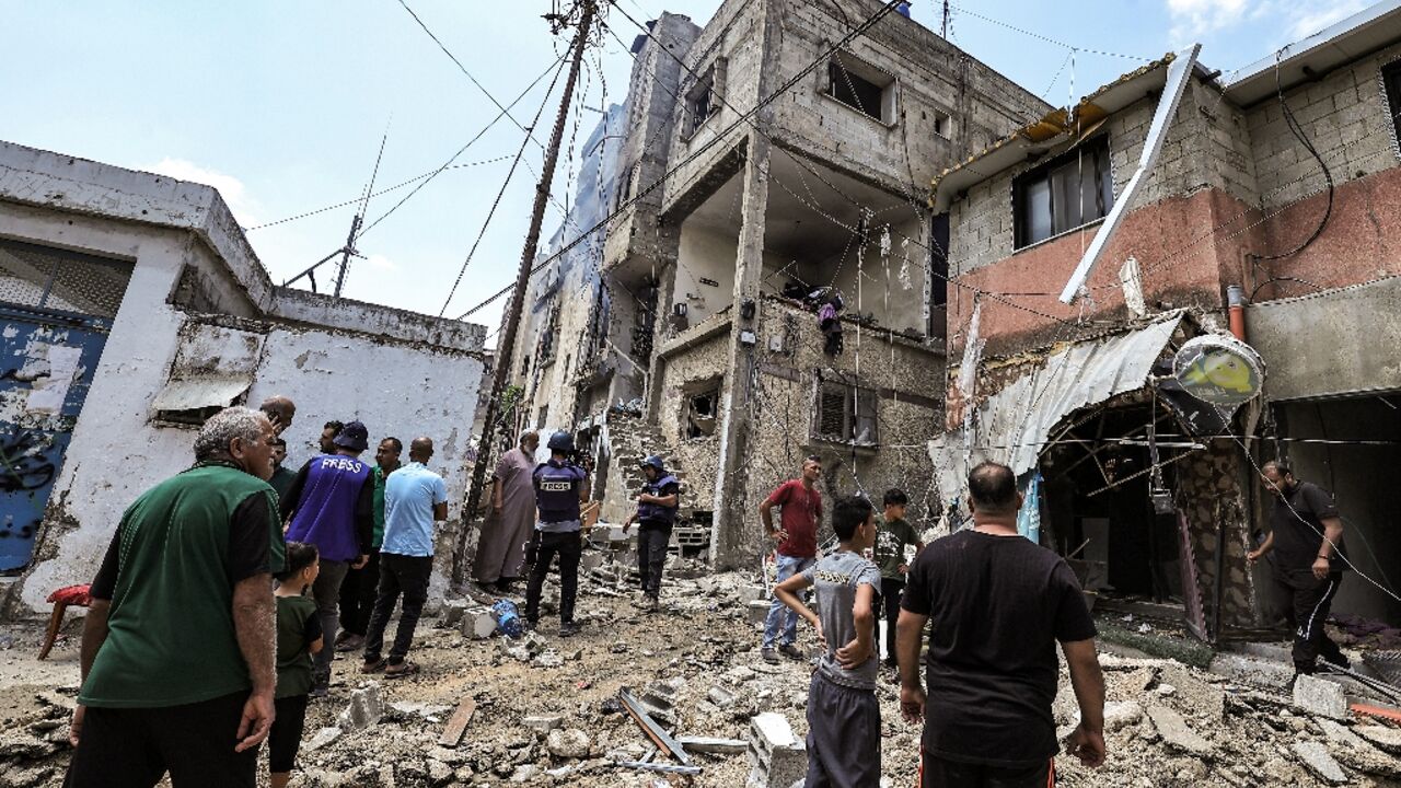 People inspect a building that was heavily damaged during an Israeli army raid on the Nur Shams camp for Palestinian refugees, east of Tulkarm in the occupied West Bank People inspect a building that was heavily damaged during an Israeli army raid on the Nur Shams camp for Palestinian refugees, east of Tulkarm in the occupied West Bank
