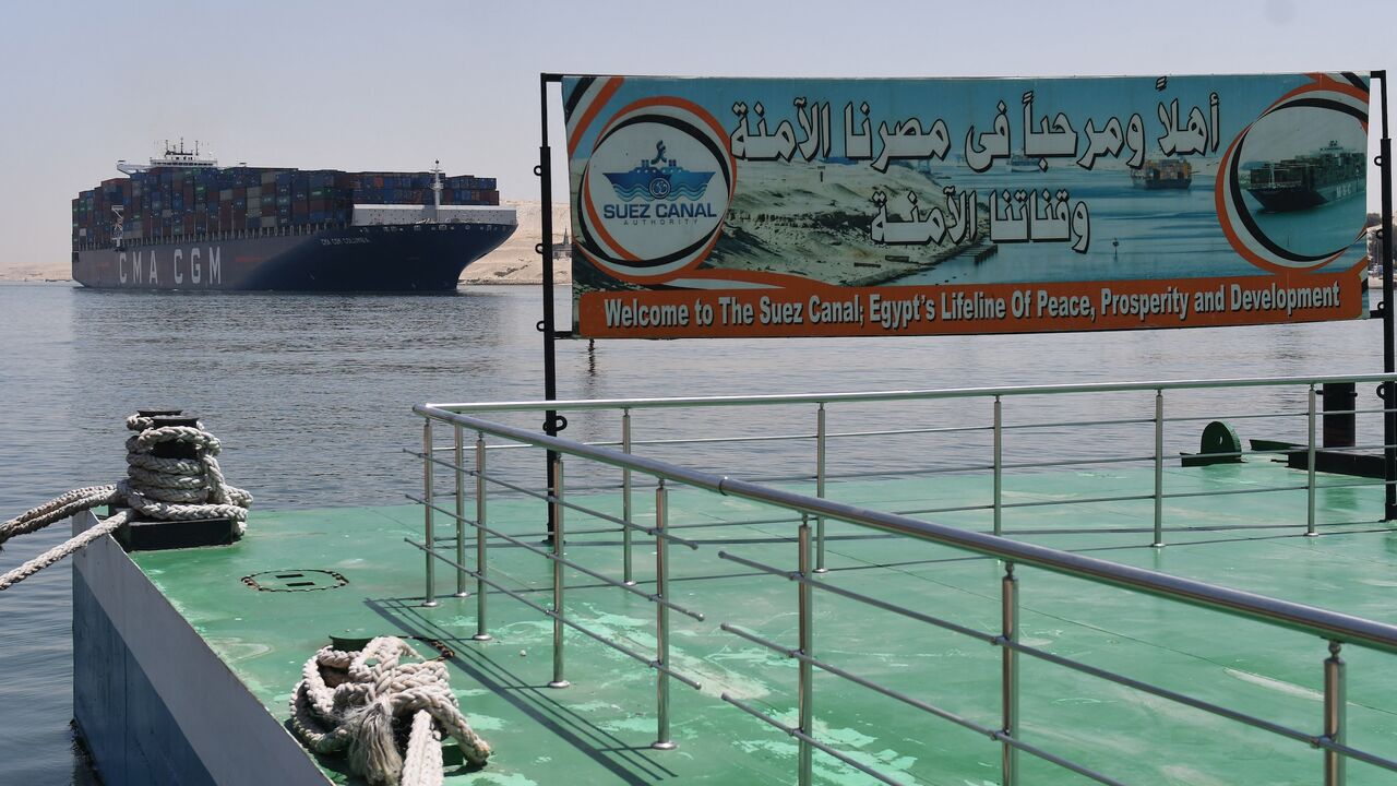 A welcoming sign is placed on the shore of the Suez Canal in the northeastern Egyptian city of Ismailiya, May 27, 2021.