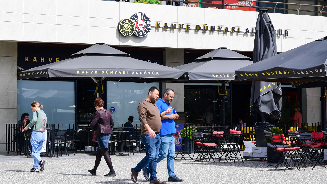 Shoppers walk past a coffee shop at a shopping mall in Ankara, Turkey on April 2, 2024.