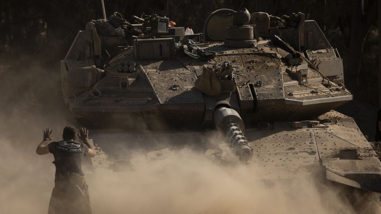 An Israeli soldier directs a tank near the border with the Gaza Strip on July 8, 2024, in southern Israel.