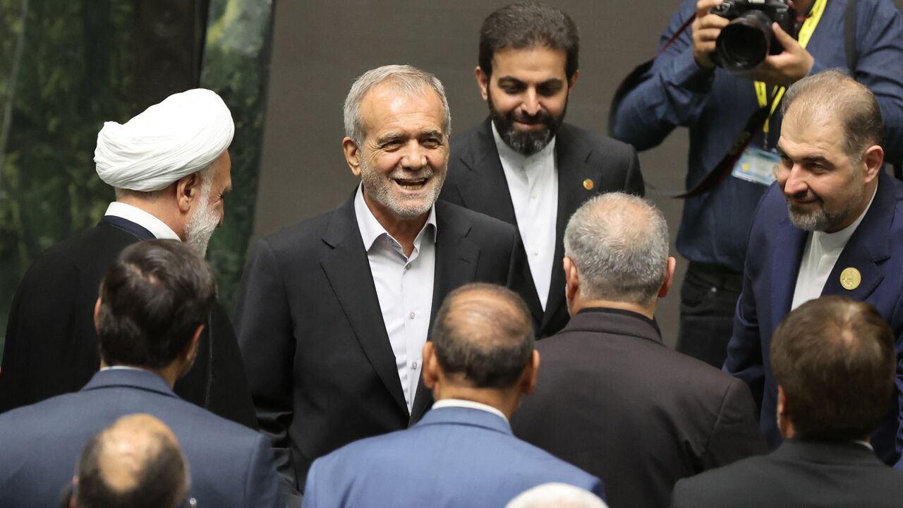 New Iranian President Masoud Pezeshkian is greeted as he arrives for the swearing in ceremony at the parliament in Tehran, on July 30, 2024.