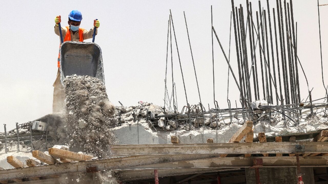 A foreign labourer works at a construction site in the scorching heat of Riyadh