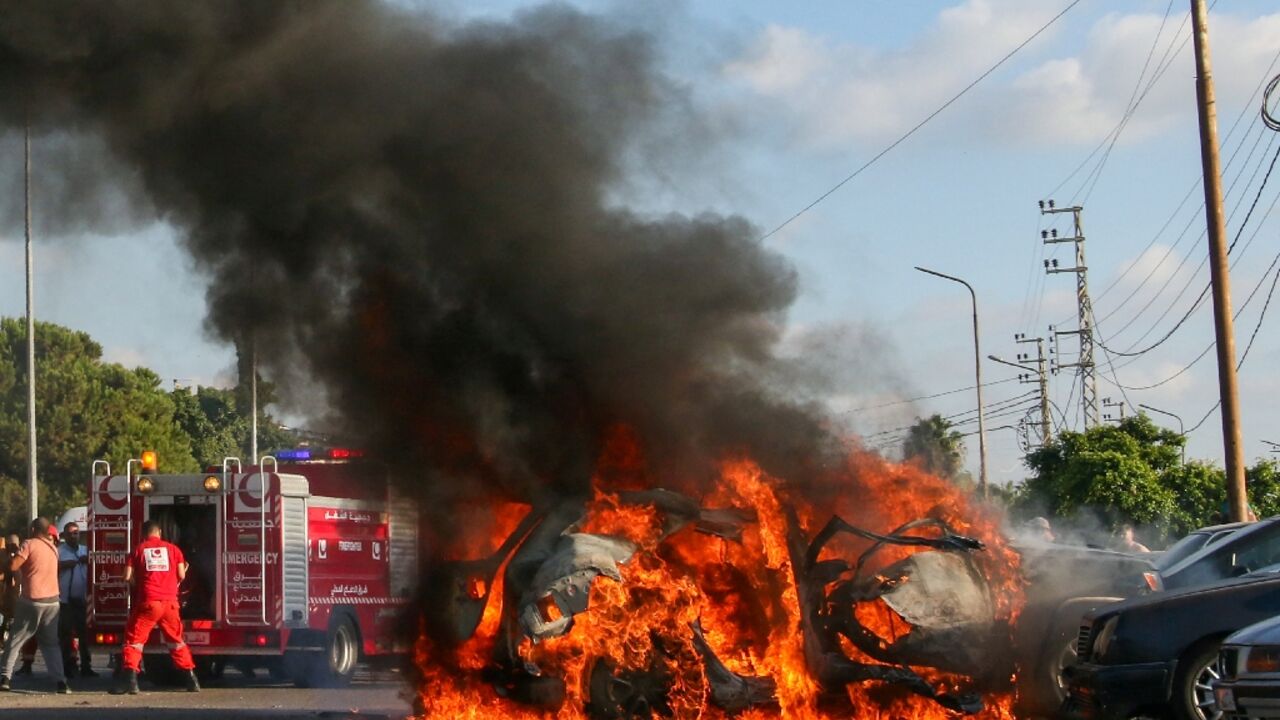 Fire engulfs the vehicle of a Hamas commander in south Lebanon after it was hit by an Israeli strike