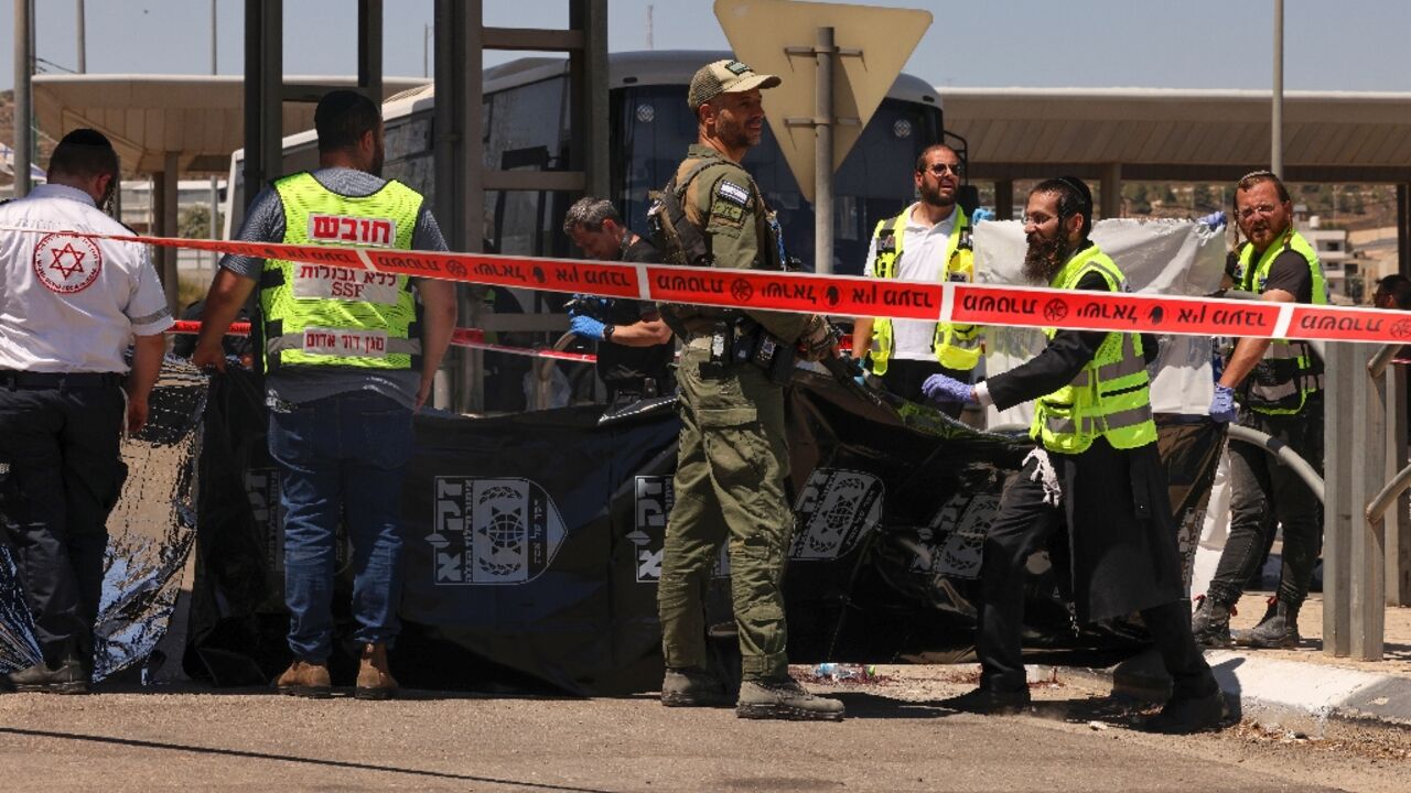 Israeli troops and medics respond after a Palestinian is shot dead at a checkpoint outside Jerusalem following an alleged stabbing attack on a border police officer Israeli troops and medics respond after a Palestinian is shot dead at a checkpoint outside Jerusalem following an alleged stabbing attack on a border police officer
