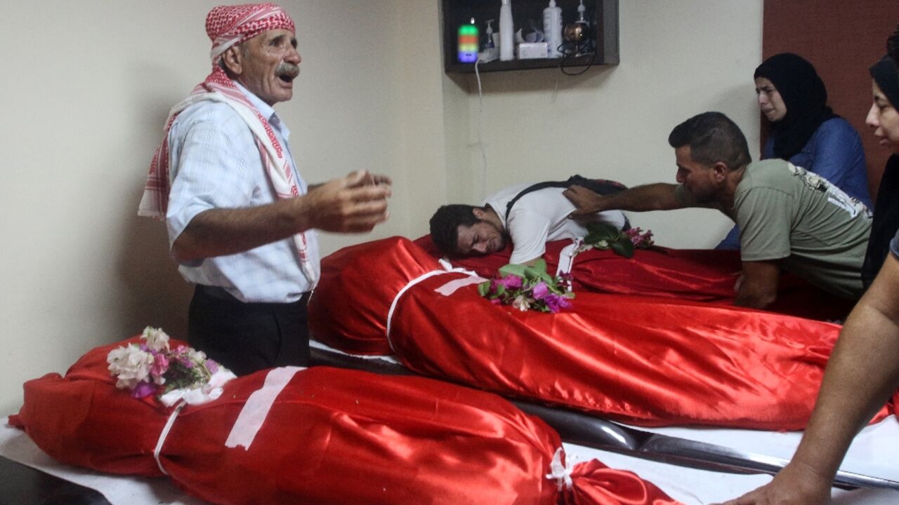 Relatives mourn over the bodies of four members of one family killed in the air strike Relatives mourn over the bodies of four members of one family killed in the air strike