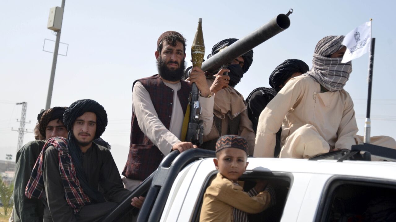 Taliban security personnel take part in a parade in Kandahar to celebrate the third anniversary of their takeover of Afghanistan