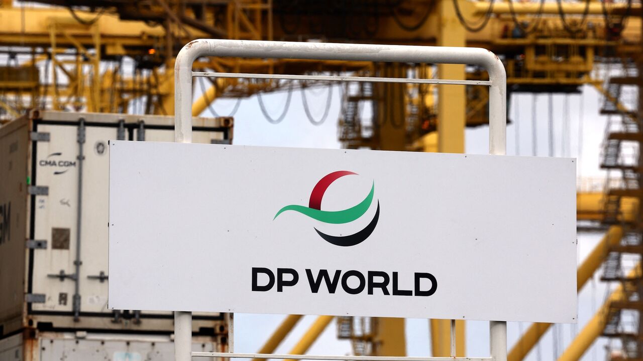 Gantry cranes are seen behind signage for ports operator DP World at an entrance to the Port Botany compound in Sydney on Nov. 13, 2023. 