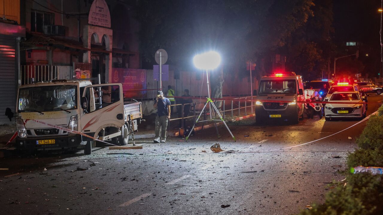 Israeli security and emergency personnel cordon off the site of an explosion in Tel Aviv, Aug. 18, 2024.