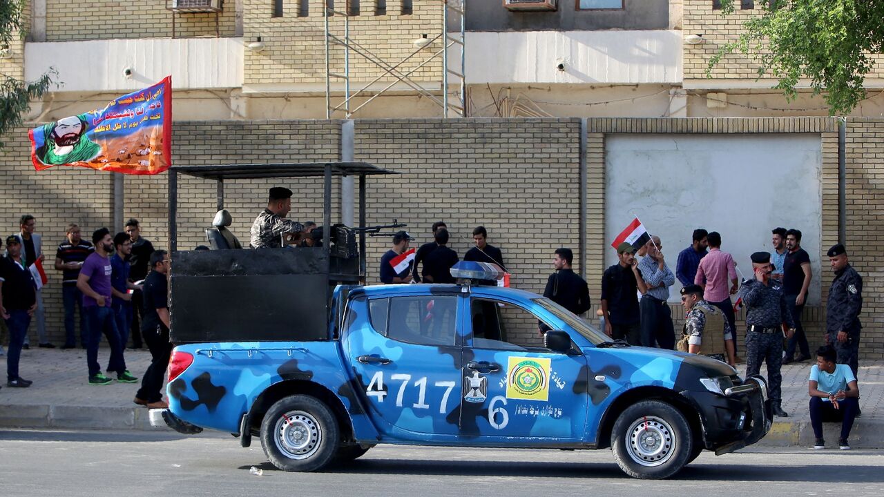 Iraqi security forces monitor the area during a demonstration to demand the withdrawal of the Turkish troops from the Bashiqa camp, located in the Mosul province, on Oct. 8, 2016, outside the Turkish Embassy in Baghdad. 