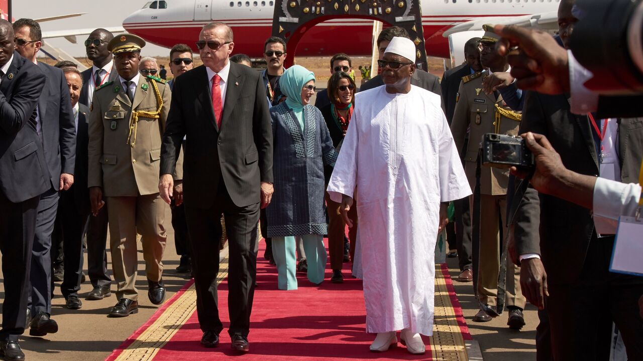 Malian President Ibrahim Boubacar Keita (R) welcomes Turkish president Recep Tayyip Erdogan (L) upon his arrival at Bamako airport on March 2, 2018.