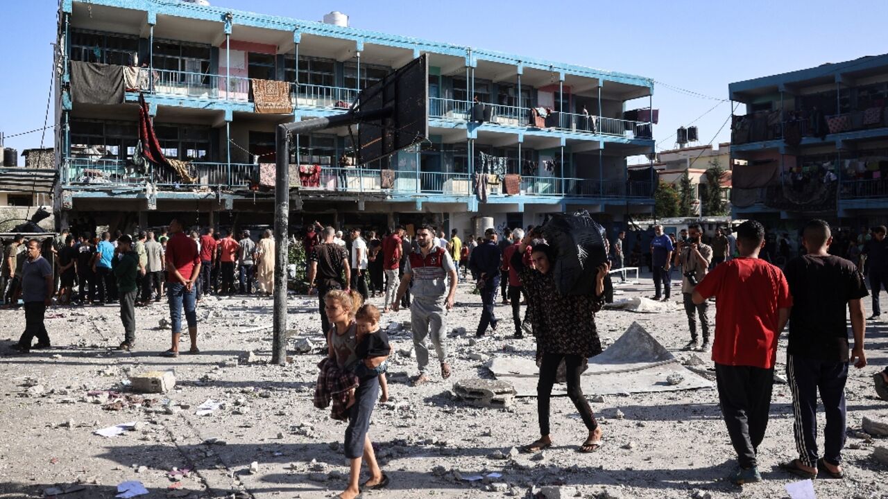 Palestinians in the courtyard of central Gaza's Al-Jawni school after an Israeli air strike