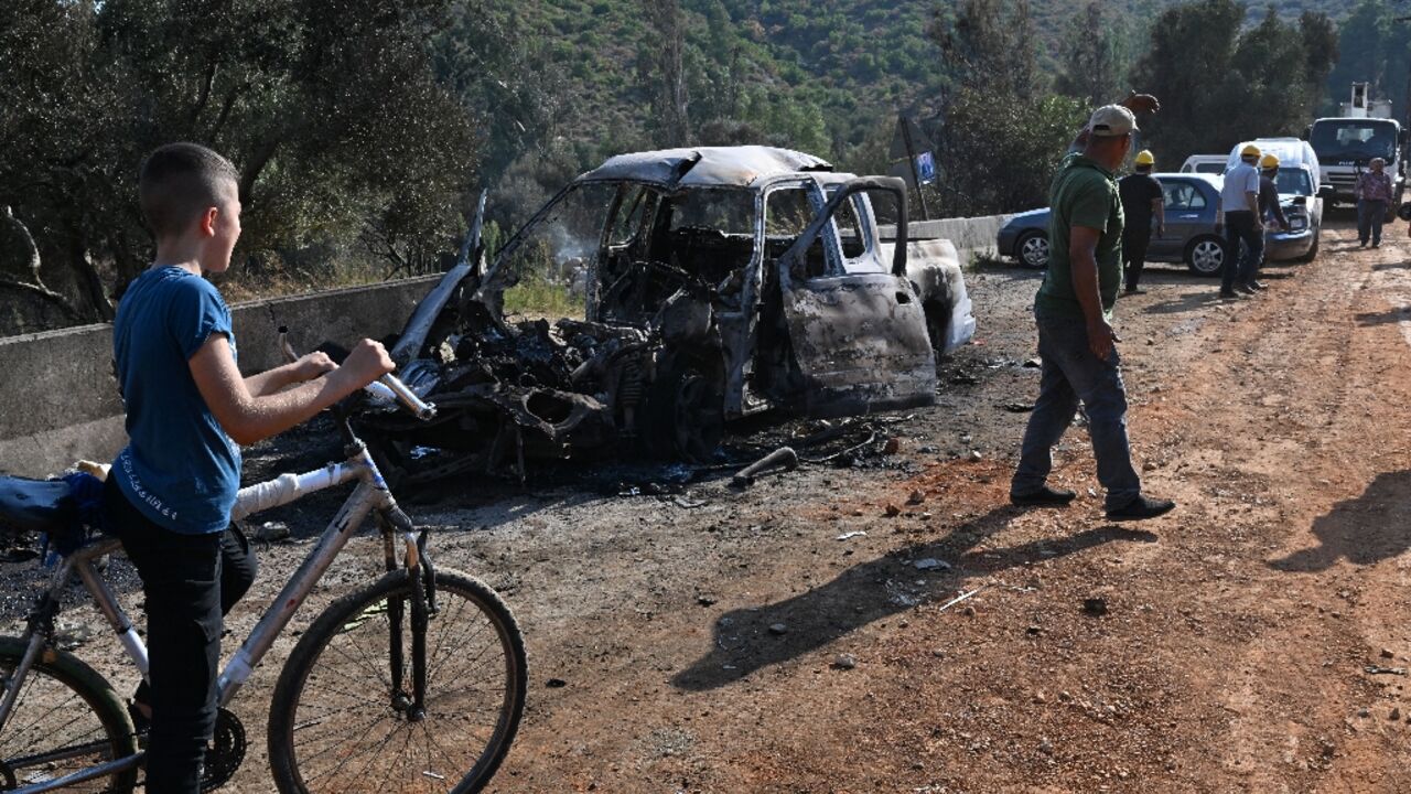 Syrians inspect the damage at the site of overnight Israeli strikes on the outskirts of Masyaf in Syria's central Hama province Syrians inspect the damage at the site of overnight Israeli strikes on the outskirts of Masyaf in Syria's central Hama province