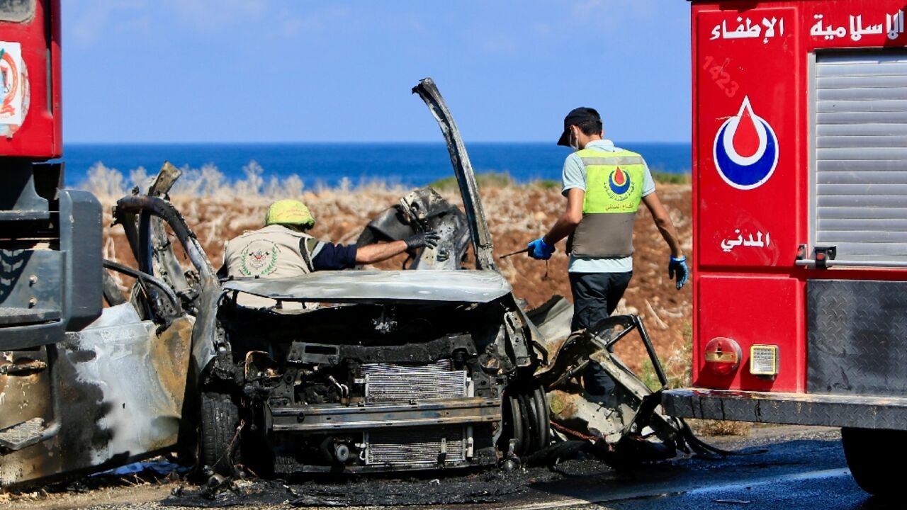 Civil Defence teams inspect a charred car that was reportedly hit by an Israeli drone strike on the road leading to the southern Lebanese coastal town of Naqura on the border with Israel Civil Defence teams inspect a charred car that was reportedly hit by an Israeli drone strike on the road leading to the southern Lebanese coastal town of Naqura on the border with Israel