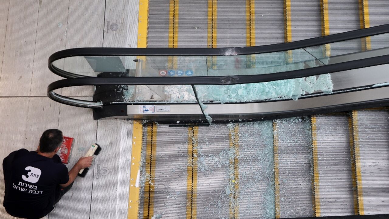 An employee at a train station in Modin, Israel, sweeps up broken glass after a missile was fired from Yemen, the military said An employee at a train station in Modin, Israel, sweeps up broken glass after a missile was fired from Yemen, the military said