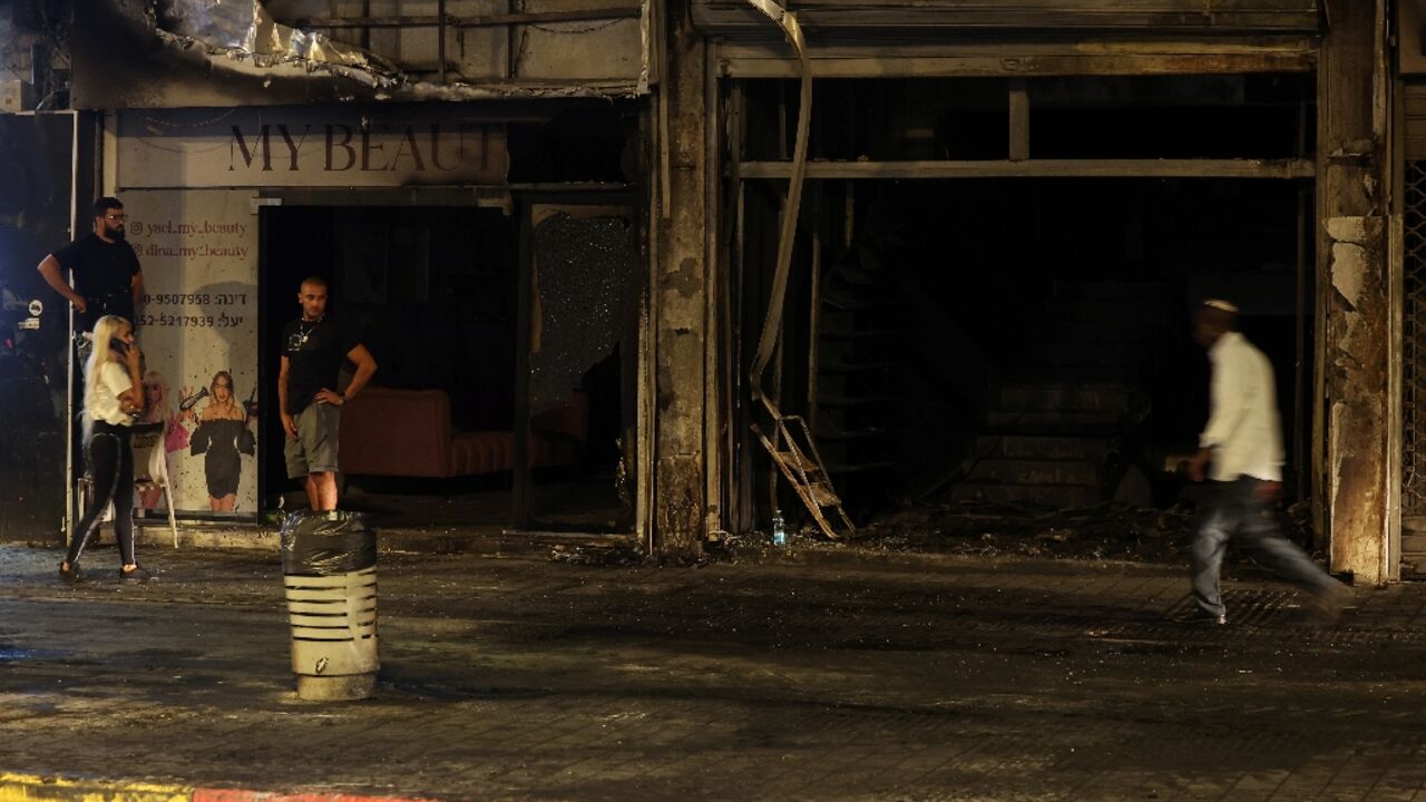 Residents inspect the damage in the Israeli city of Ramla from a deadly car explosion that police say was likely a gangland hit.