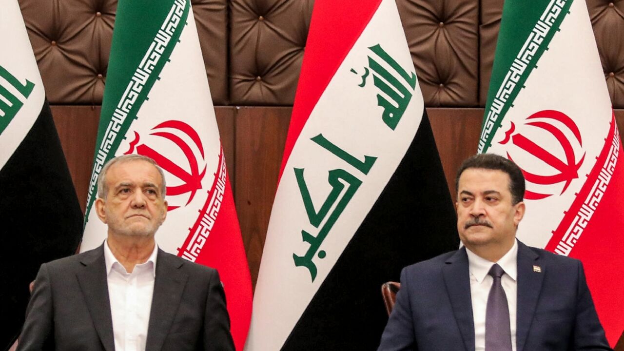 Iraqi Prime Minister Mohammed Shia al-Sudani (R) and Iranian President Masoud Pezeshkian attend a ceremony for the signing of memoranda of understanding in Baghdad